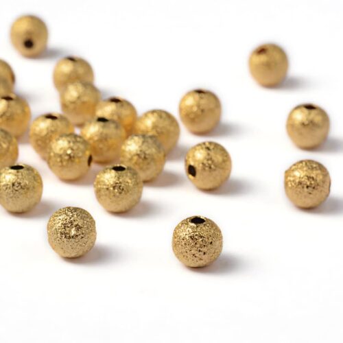 Perles stardust en métal doré 6mm - Lot de 50 unités
